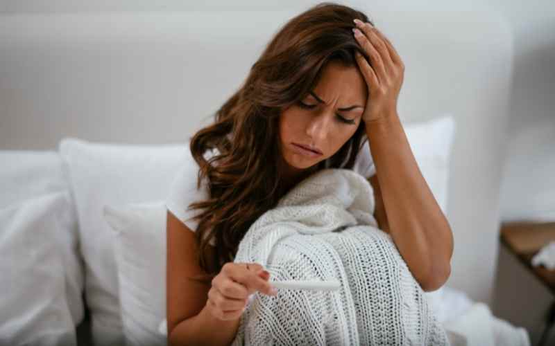 Sốt nhẹ cũng là một dấu hiệu mang thai điển hình ở phụ nữ. (Ảnh: Sưu tầm Internet)